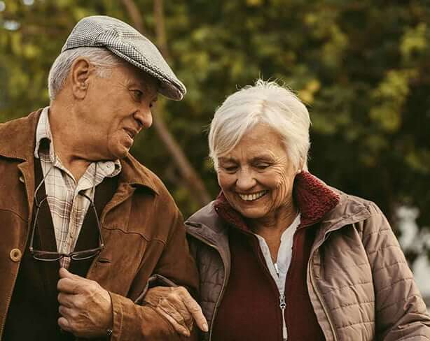 Couple walking linking arms